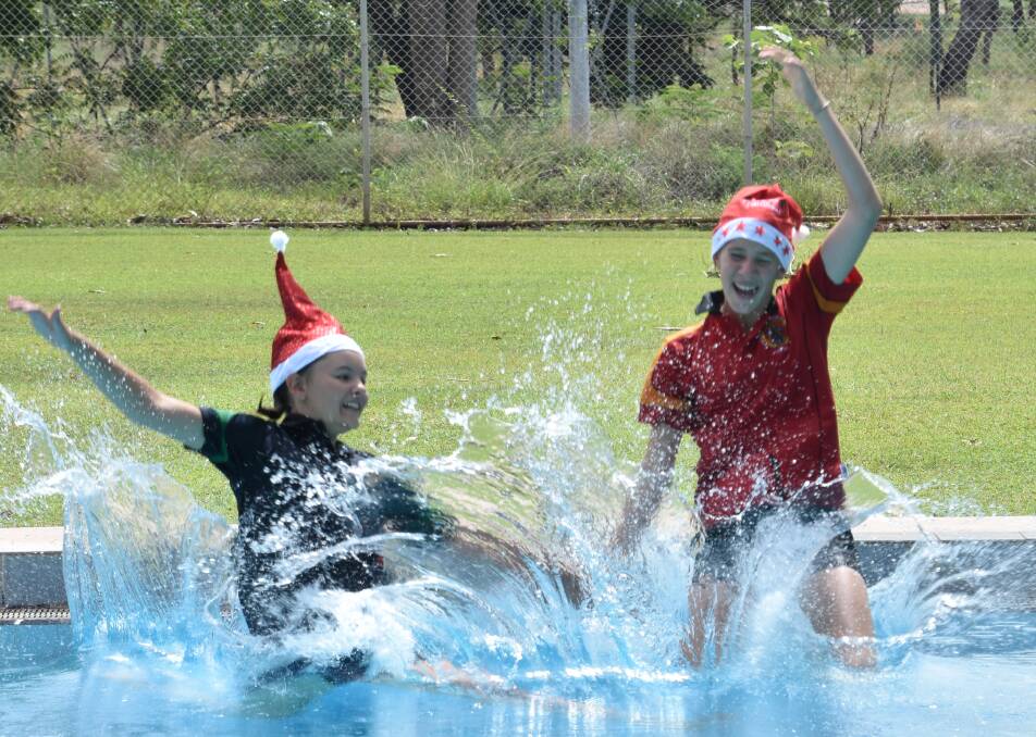 CHRISTMAS CHEER: 2019 Katherine School of the Air school captain Shae Ford and vice captain Sharlette Johnson enjoy the week-long swimming carnival held in Katherine in the lead up to Christmas.  