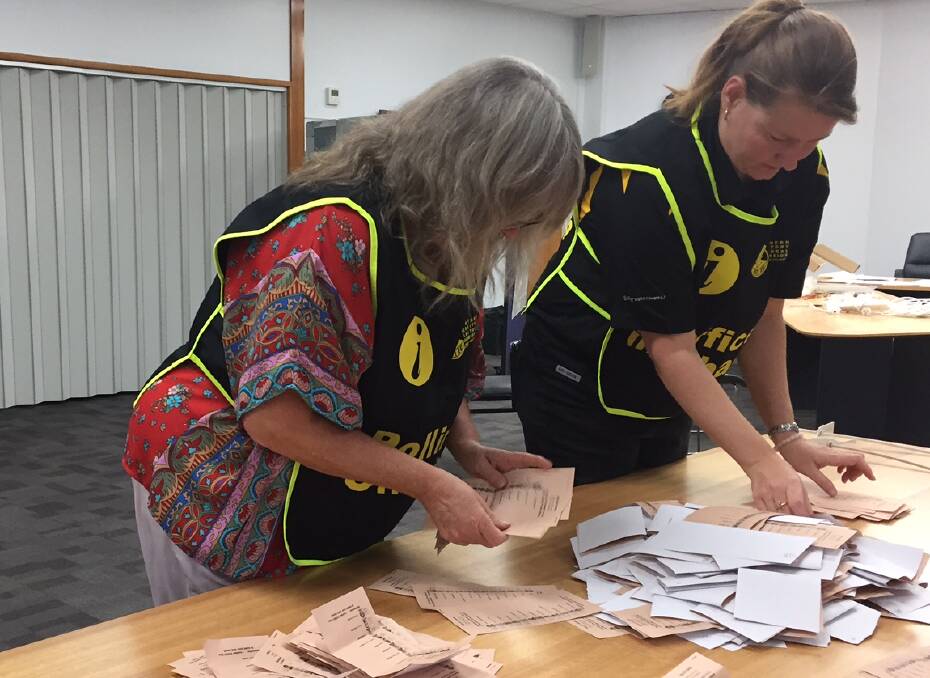 COUNT CONTINUES: The count of first preference votes at the Katherine Civic Centre on Saturday night. Picture: Lydia Lynch.