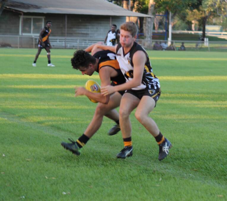STRONG TACKLE: This Tiger dropped the ball under a fierce tackle near the boundary line so there was no doubting the willingness of the Hawks.