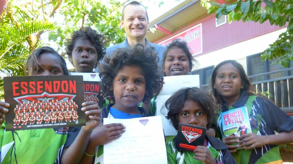 ROYAL RESPONSE: Students Hadassah Ashley-Brumby, Nathan Alangale, Aralise Fredricks, Alice Fredricks, Dastan Wurramarrba, Susan Lawrence with gifts from Essendon Football Club and Ben Kleinig (teaching principal). Picture: supplied.