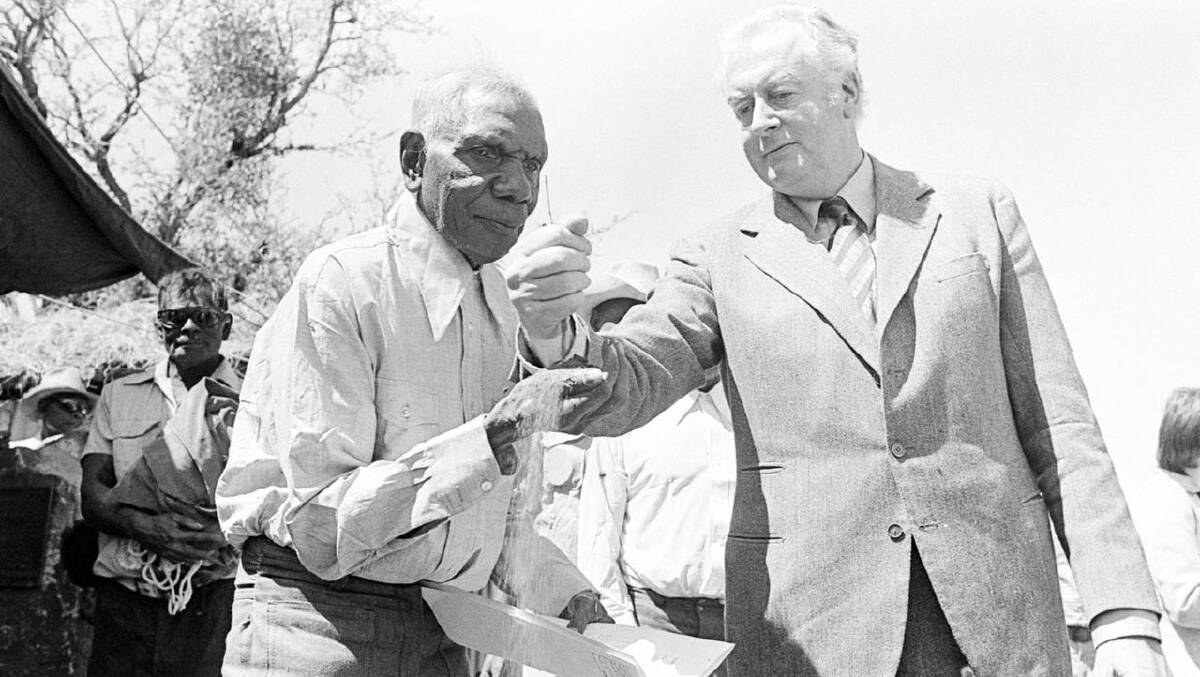 LANDMARK: In 1975, then Prime Minister Gough Whitlam poured soil into the hands of senior Gurindji man Vincent Lingairi to mark the return of much of the station to his people.