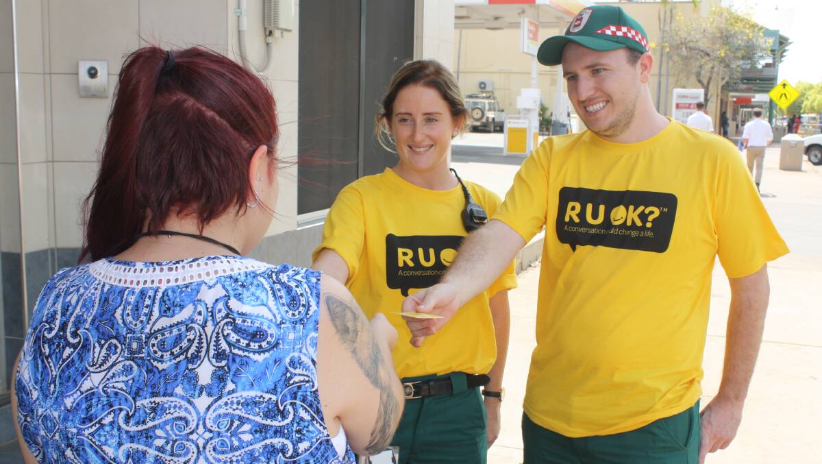 R U OK: Paramedics Amanda Newberry and Rhys Gloury handed our R U OK cards in Katherine today.