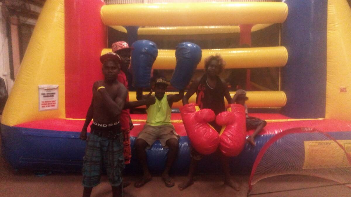 GLOVES ON: Numbulwar youth have a blast with their community's new inflatable boxing ring and giant boxing gloves. Photo: Supplied.
