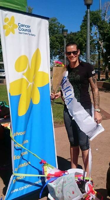 Alicia Bannerman was given a sash and flowers when she completed her 330km walk via treadmill to raise money for the Cancer Council.
