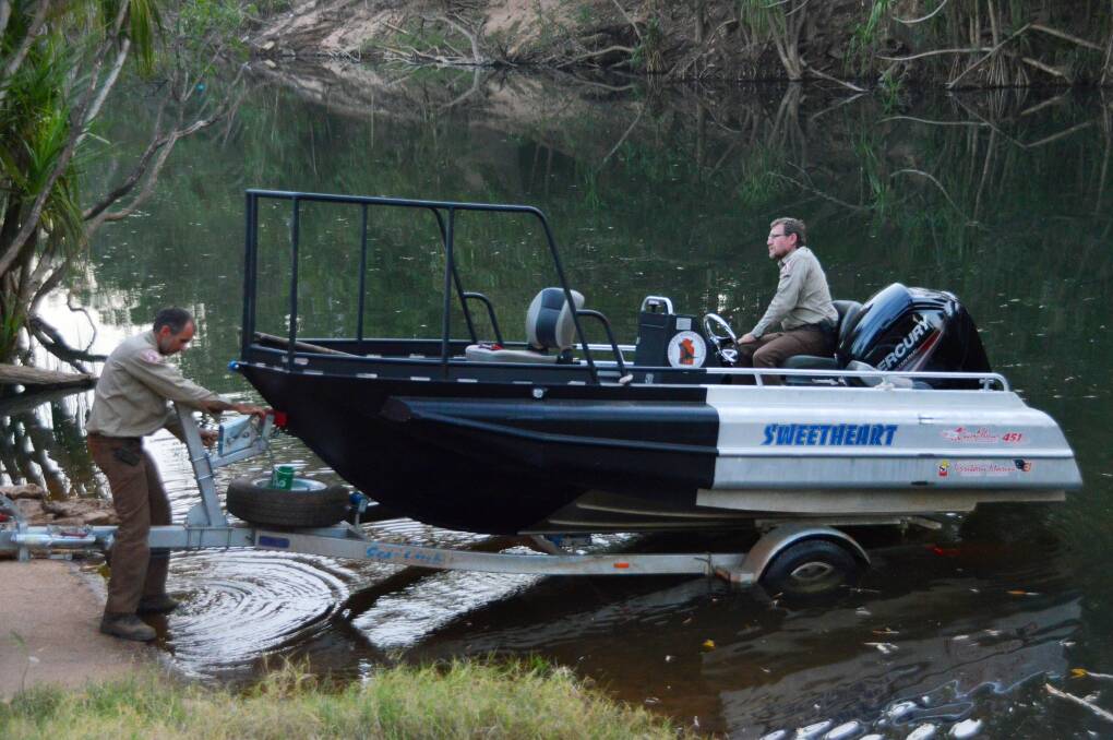 Rangers John Burke and Chris Heydon put Sweetheart, the Katherine crocodile management team's new boat, into the Katherine River on August 19.