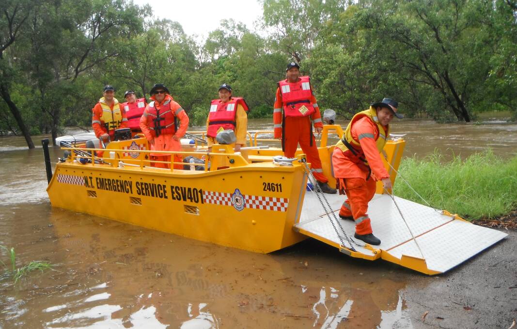 Members of Katherine's NT State Emergency Service volunteer unit test the new flood boat in the swollen river last week.