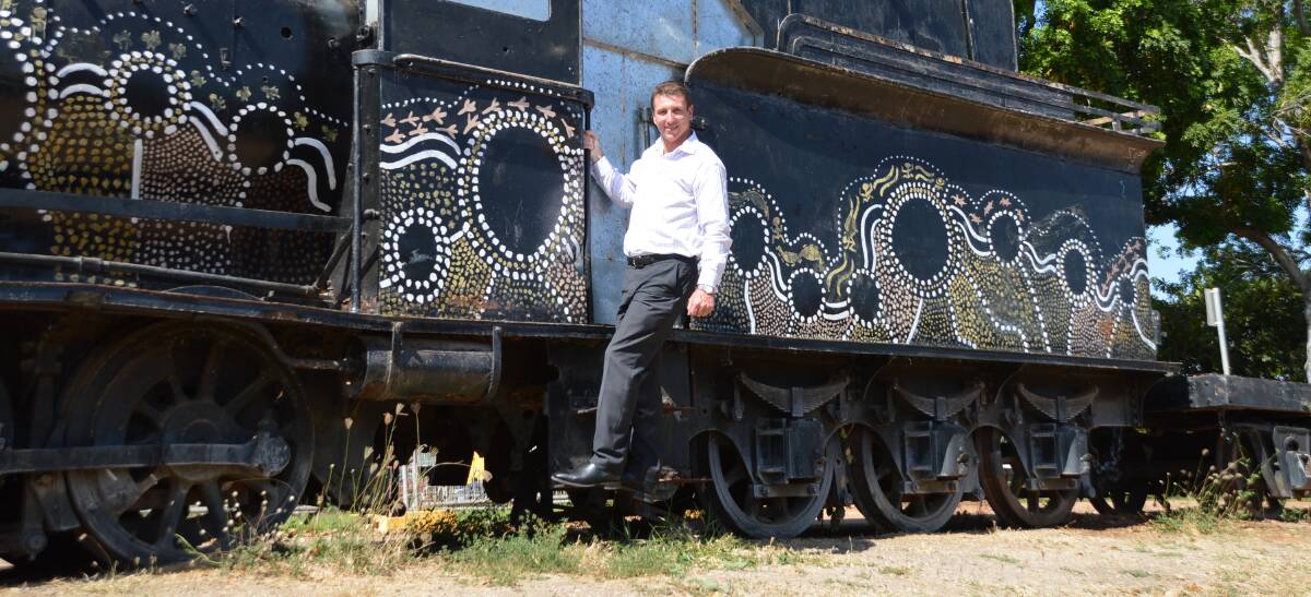 ALL ABOARD: Member for Katherine Willem Westra van Holthe has a bit of fun on the historic 1892 locomotive before it is relocated to the town's existing railway precinct.