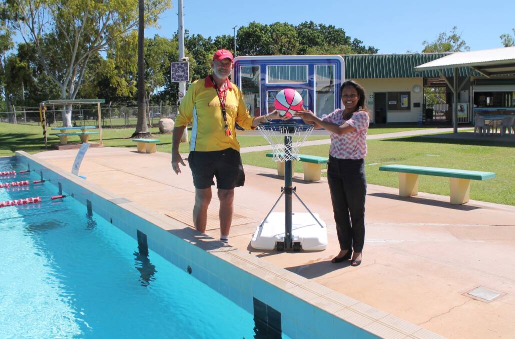 POOL PLAY: Katherine Aquatic Centre pool manager Dennis Watson and Katherine Regional Community Bank branch manager Subha Pathirage test out the new hoops.