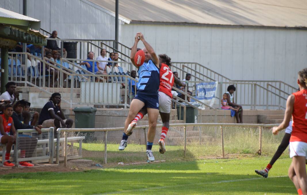 FURIOUS FINISH: Mark Derksen and Jared Ross fly high for a mark on the boundary during Eastside Football Club's thumping 180-point demolition of the Lajamanu Swans on August 29.