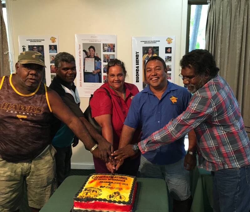 REMOTE COMMITMENT: Charlie Newry, Joseph Archie, Rhonda Henry, Brian Pedwell and Norbert Patrick cut a cake recognising the efforts of dedicated Katherine West Health Board senior Aboriginal health practitioners during 2015.
