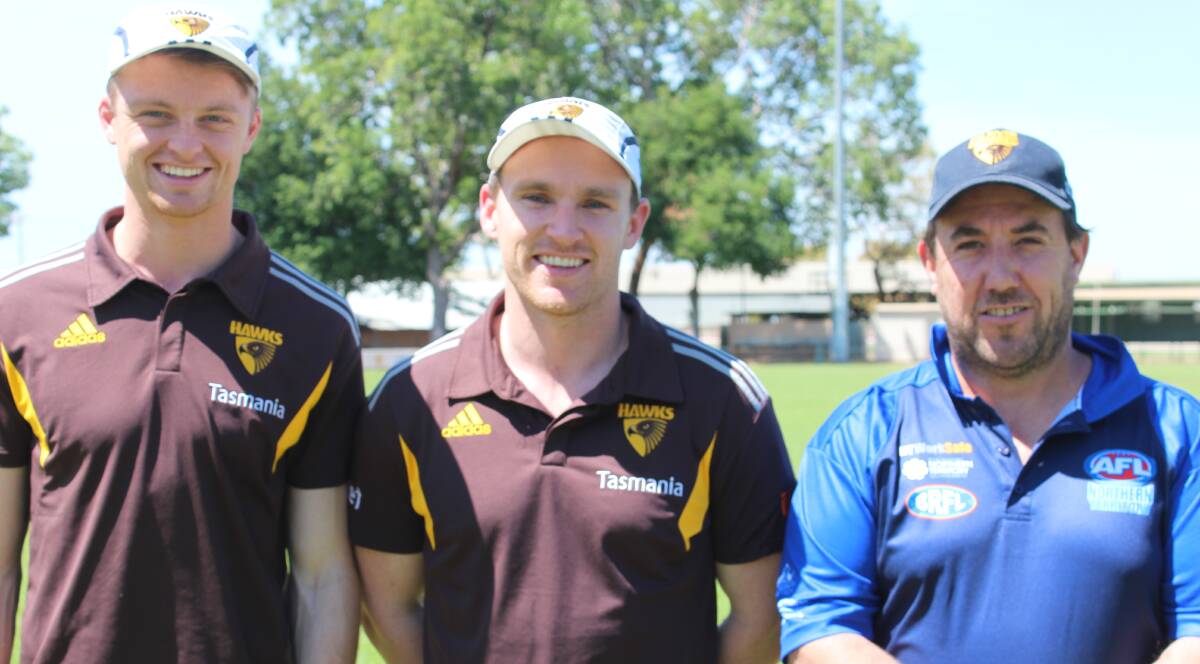 DEVELOPMENT: Hawthorn Hawks' representatives Mitchell Chasio and Nathan Foley with AFL Northern Territory Katherine regional manager Eamon Rice at Nitmuluk Oval.