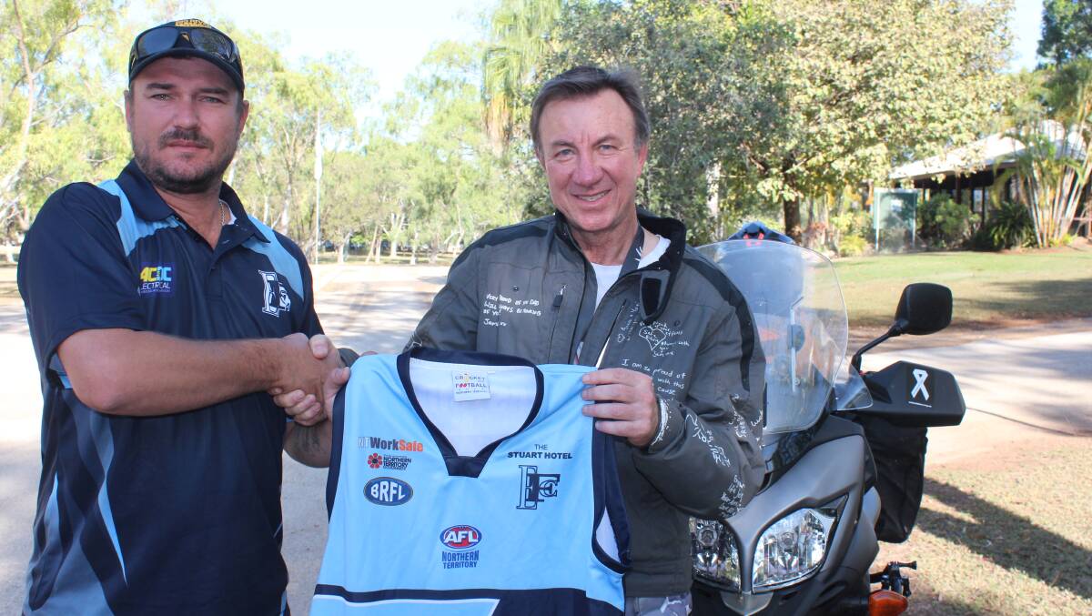 CONVERSATION: Eastside coach Greg Bain presenting Ivan Phillips with an Eastside jersey following Mr Phillips' presentation to the team. Photo: Eric Barker