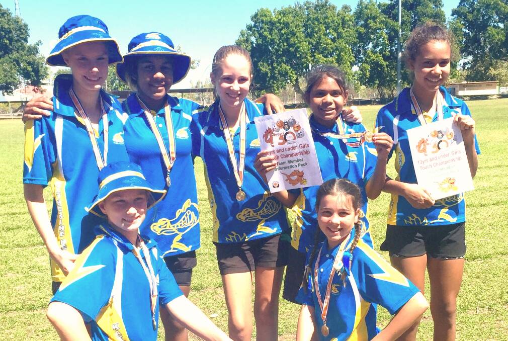 CHAMPIONS: Katherine under 12 touch players (back) Brianna Simmonds, Kayla Costello, Taylor Hohn, Nyokah James, Elyssia Talon-Rosas (front) Charlize Simmonds and Jasmine Glass celebrate making the Northern Territory team.