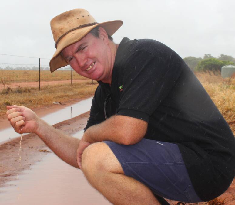 WELCOME RAIN: Katherine mango grower Mitchell Curtis is embracing the unseasonal September deluge which has allowed him to turn the irrigation pumps off for the next week. Picture: Eric Barker