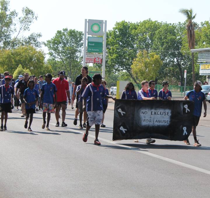 WALKING TALL: A group of Katherine High School students swapped the classroom for the blacktop last Wednesday to spread the "no excuse for abuse" message as they took part in the White Ribbon Muster to Ryan Park.