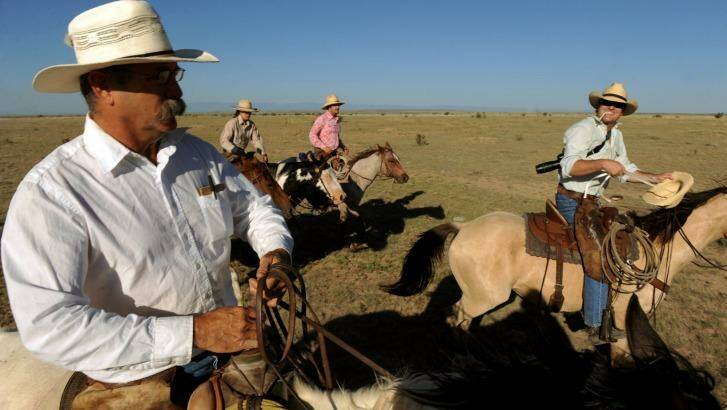 Rancher Duke Phillips, left and Western painter Duke Beardsley, right, ride together for the last round up of cattle for the season.  Photo: Helen H. Richardson