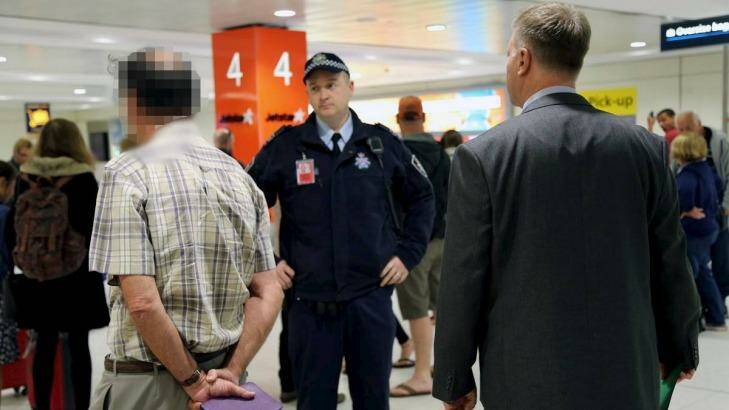  Former St Mary's Cathedral College principal David Standen is arrested at Sydney Airport. Photo: Supplied