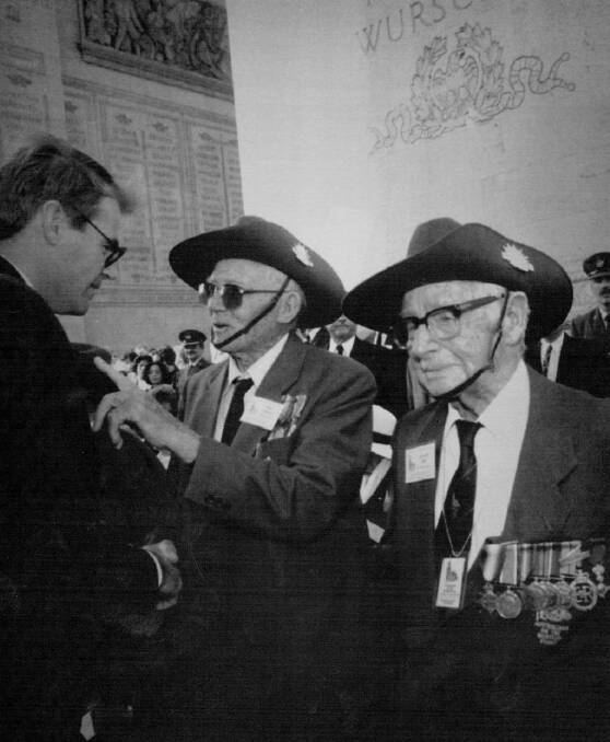 Australian War Veterans Minister John Faulkner, left, shakes hands with Australian World War I veterans Peter Casserty, centre, and Edward Charles Field after the remembrance ceremony in Paris, 1993.