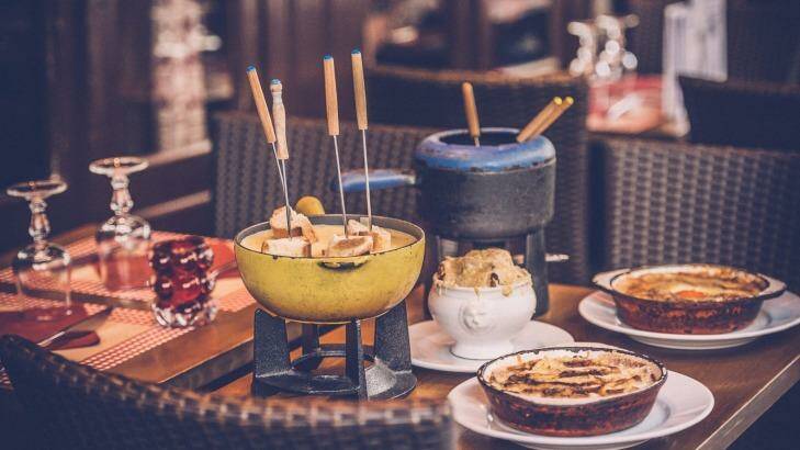 Parisian street cafe with an earthenware pot (caquelon) for fondue. Photo: IStock