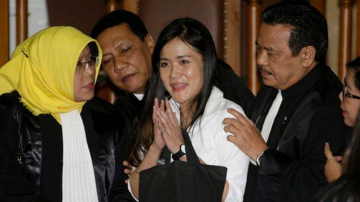 Jessica Kumala Wongso, centre, flashes a smile as she is surrounded by her lawyers after her jail sentence at a courtroom of Central Jakarta District Court.  Photo: AP/Tatan Syuflana