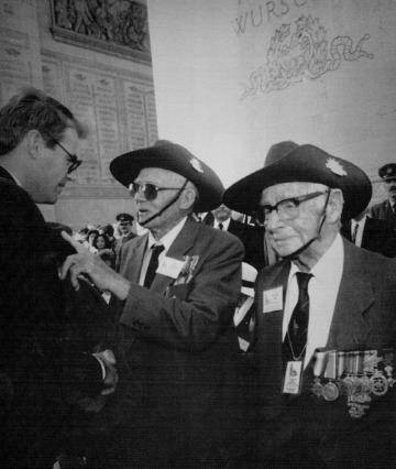 Australian War Veterans Minister John Faulkner, left, shakes hands with Australian World War I veterans Peter Casserty, centre, and Edward Charles Field after the remembrance ceremony in Paris, 1993.