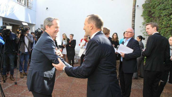 Bill Shorten and Tony Abbott shake hands in Sydney on Monday Photo: Peter Rae