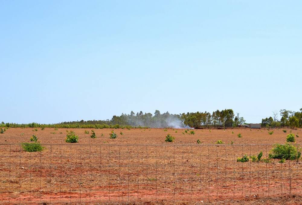 Smoke rises from a Fox Road watermelon farm as Katherine producers hit by CGMMV continue to destory their crops.