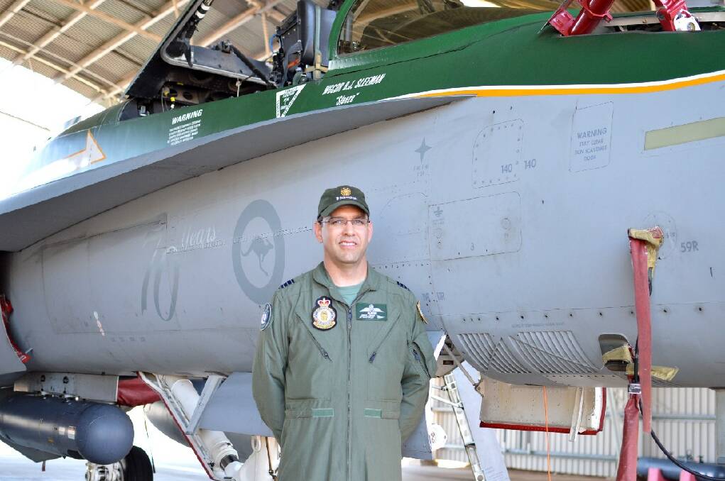 SUPERSONIC VISITORS: 77 Squadron commanding officer Wing Commander Ben Sleeman shows off his F/A-18 Classic Hornet.