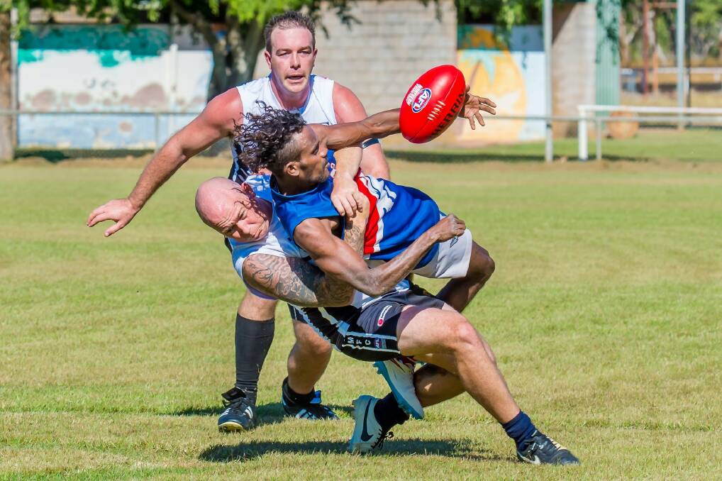 LAST MAN STANDING: David Standing gives his all for the Tindal Magpies during an athletic contest for possession against the Ngukurr Bulldogs at Nitmiluk Oval on May 23. Photos: CASEY BISHOP