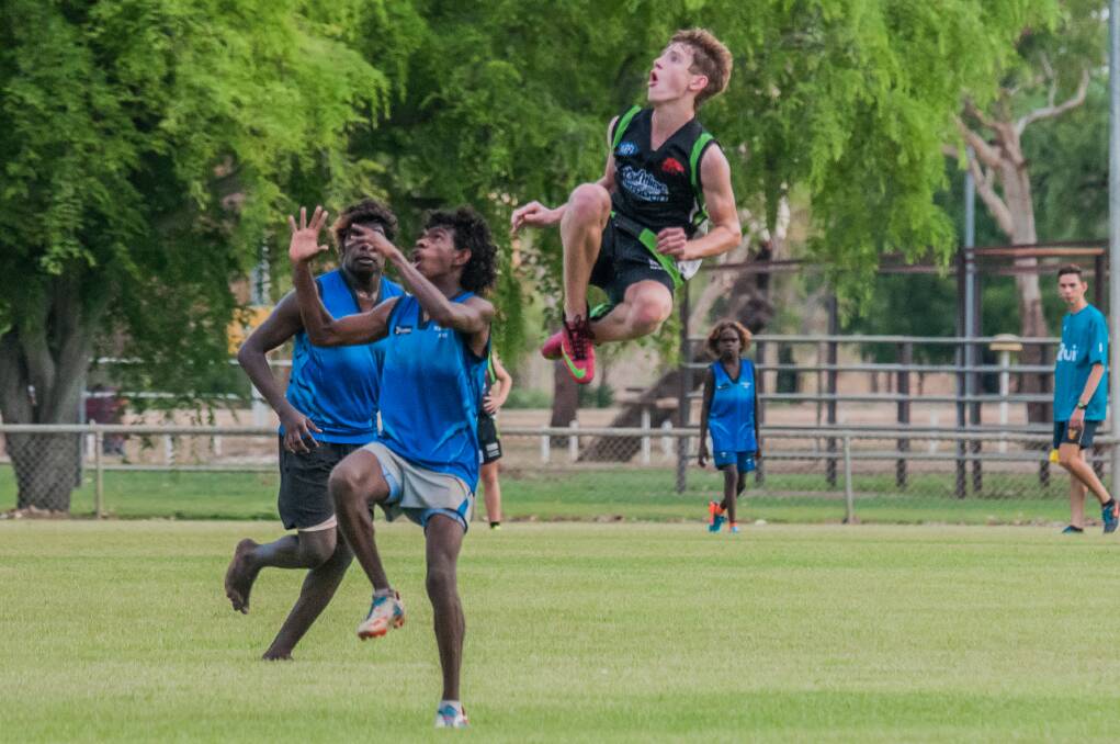 SKY HIGH: Mat Jackson soars above his opponents for the Katherine Camels during the team's game against Jilkminggan Souths on Saturday afternoon. Photos: CASEY BISHOP