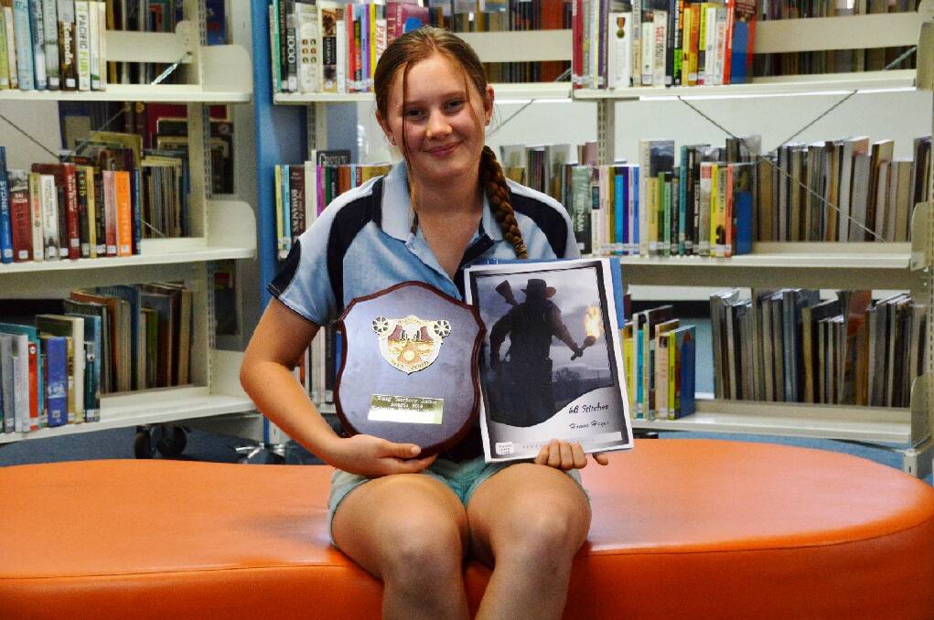 TOP MARKS: Hanna Hayes shows off her prize for excelling in the 2014 Young Territory Author Awards.
