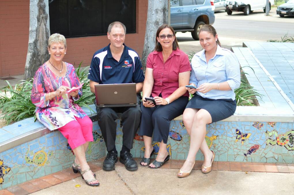 TURNING ON: Katherine Town Council mayor Fay Miller, Kevin Grey, community services executive manager Sophie Henderson and chief executive officer Neroli Dickens road test the new Wi-Fi.
