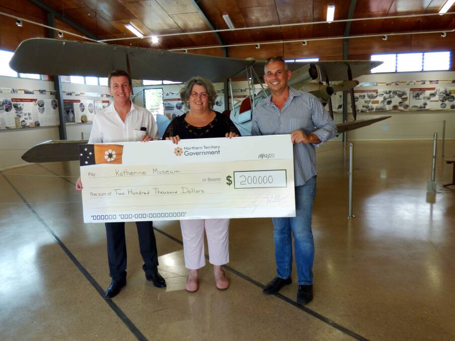 HISTORICAL HELP: Member for Katherine Willem Westra van Holthe and Chief Minister Adam Giles present Katherine Museum curator Simmone Croft with a $200,000 grant to help air condition the display housing Dr Clyde Fenton’s iconic Gipsy Moth during a surprise visit in December.