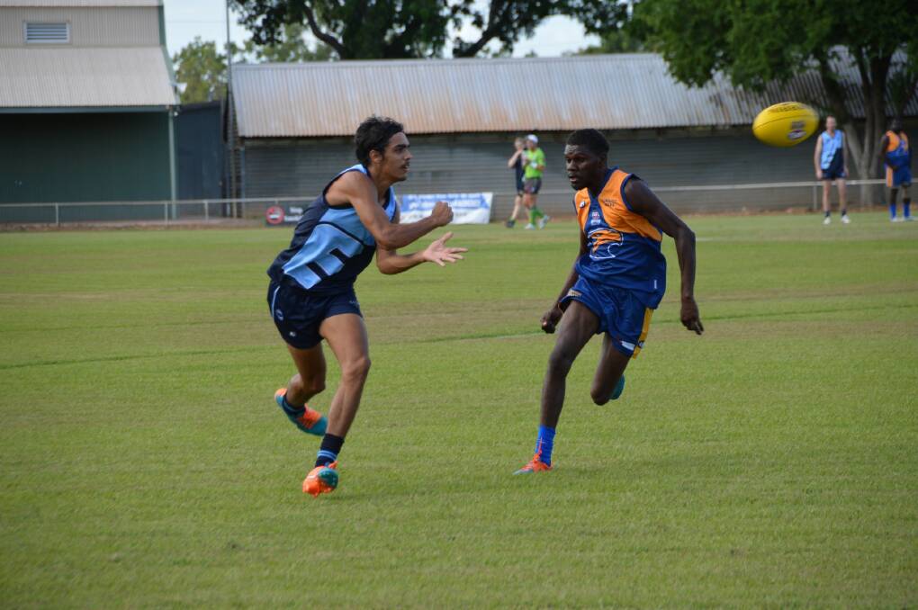 ELECTRIC EASTSIDE: Kevin Moroney gets a handball away before being run down by his Gurindji Eagles opposite number on Saturday afternoon.