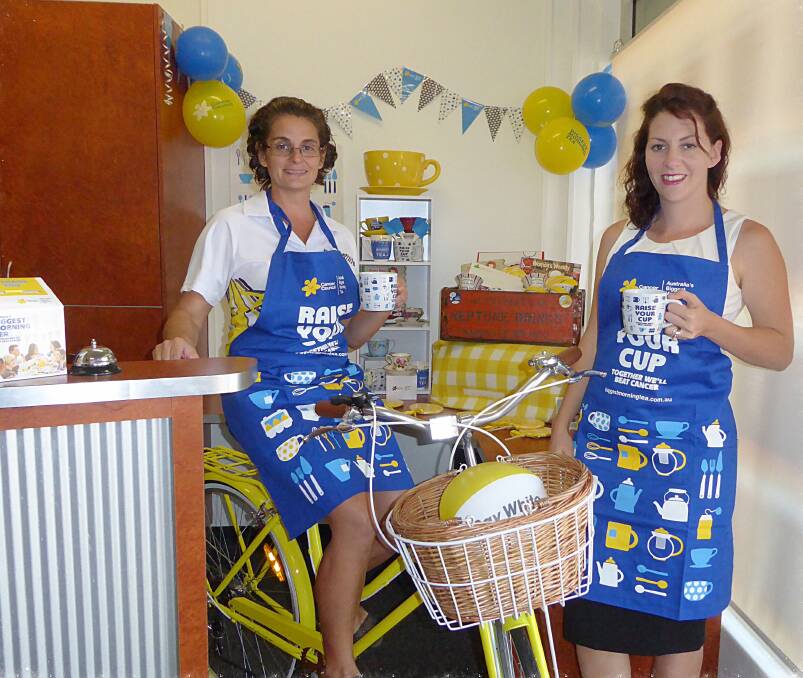 FUNDRAISING FUN: Ray White Katherine staff  Doris Baylis and Lauren Reed get ready for the company’s traditional Biggest Morning Tea on May 28.