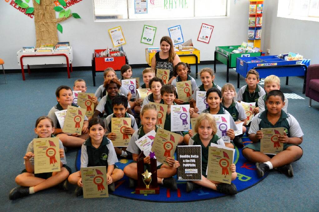 St Joseph’s Catholic College Year 3/4D students celebrate after collecting their certificates for winning the school division of the 2014 Young Territory Author Awards on Thursday morning.