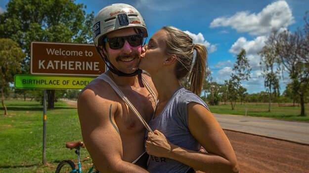 OVER THE LINE: Dan Mewing is congratulated by his wife, Nicolette, after riding from Darwin to Katherine for Movember.