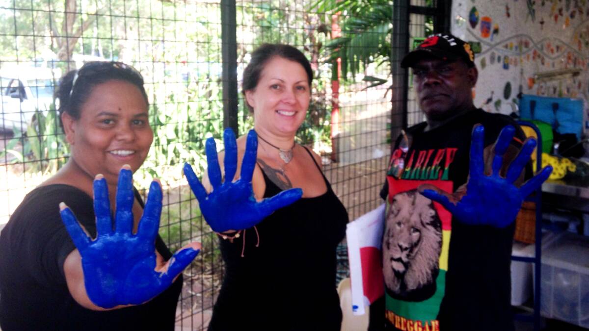 HANDS OFF: Helena Gulwa, Charmaine Roth and Eddie Mason go blue to send a colourful signal to the Northern Territory government about fracking in Darwin last week.