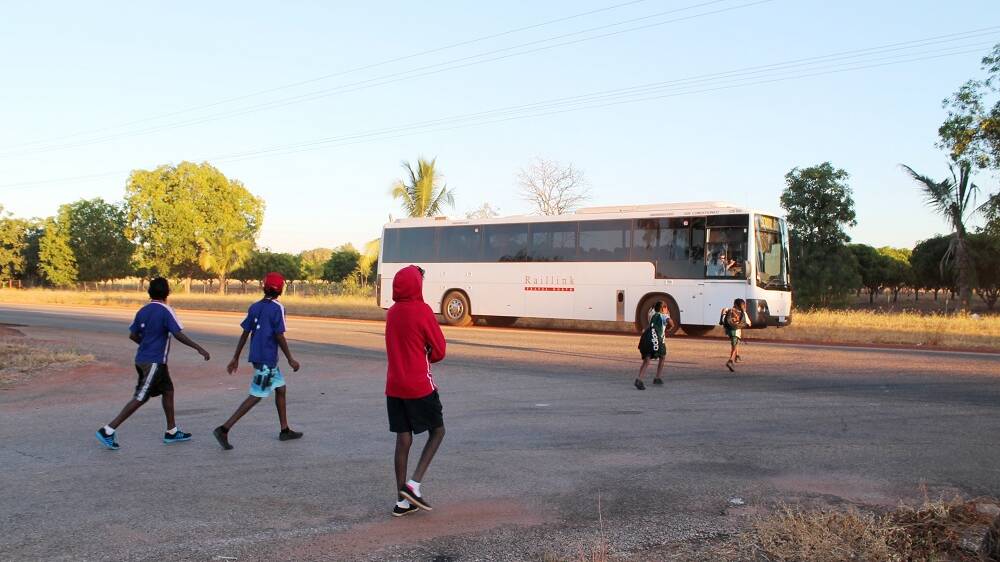 TEMPTING FATE: Children run across an 80km/h section of Florina Road to catch their school bus on 26 May. Photo: Stephanie Zillman