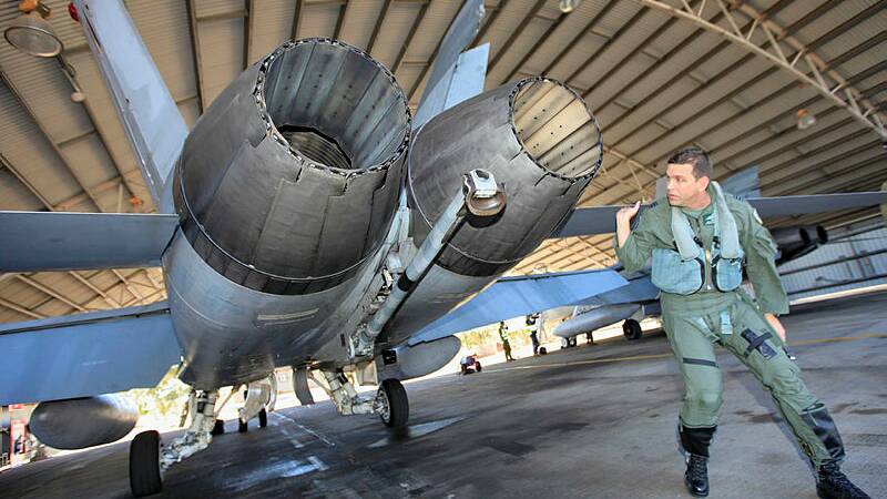 CLASSIC HORNET: Commanding Officer No. 77 Squadron, Wing Commander Benjamin Sleeman  conducts a walk around of his F/A-18 Classic Hornet at RAAF Base Tindal. Picture: defence media. 