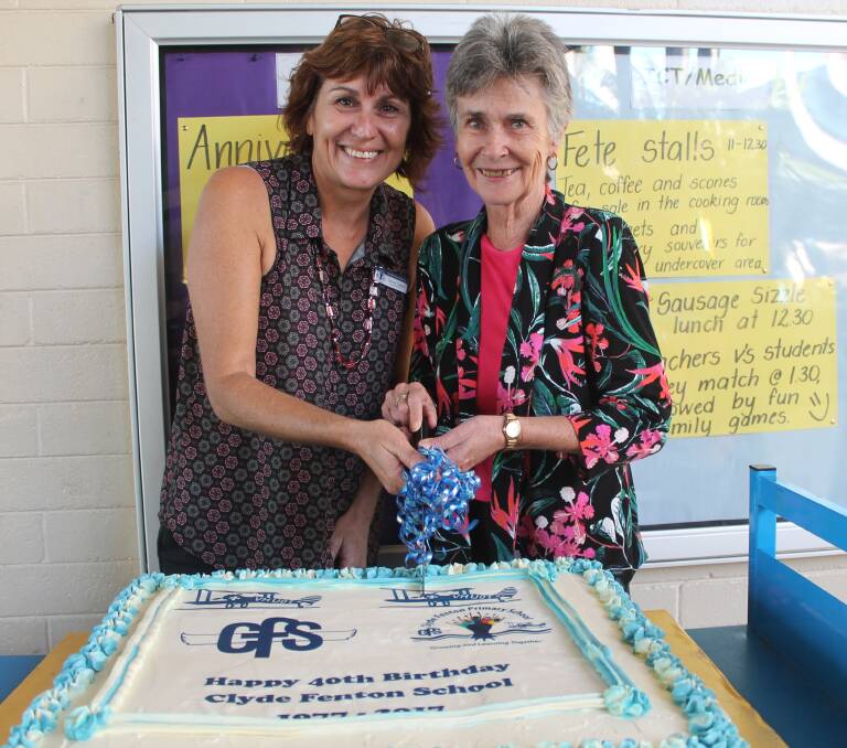 FORTY YEARS: Assistant principal Donna Capes and former principal Sandy McCue cut the anniversary cake. 