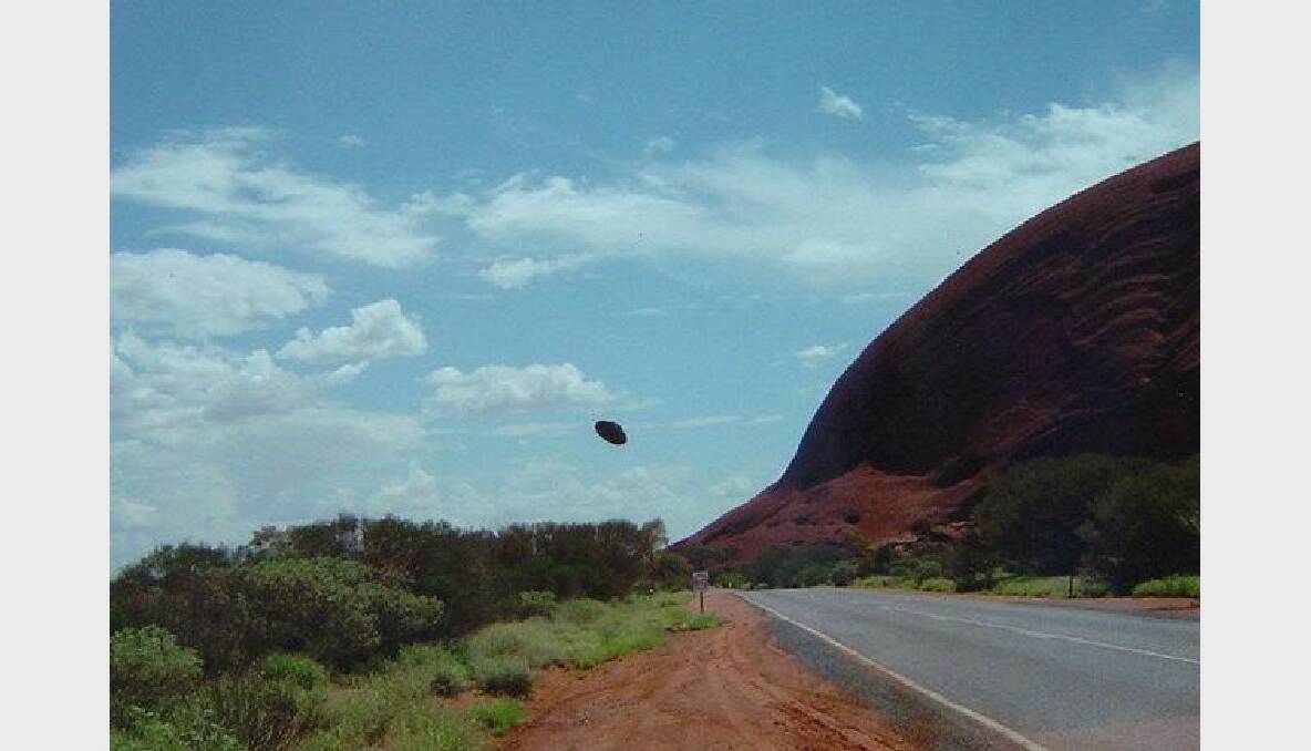 This photo was taken in Central Australia. It is unclear what the object is that can be seen flying through through the sky.