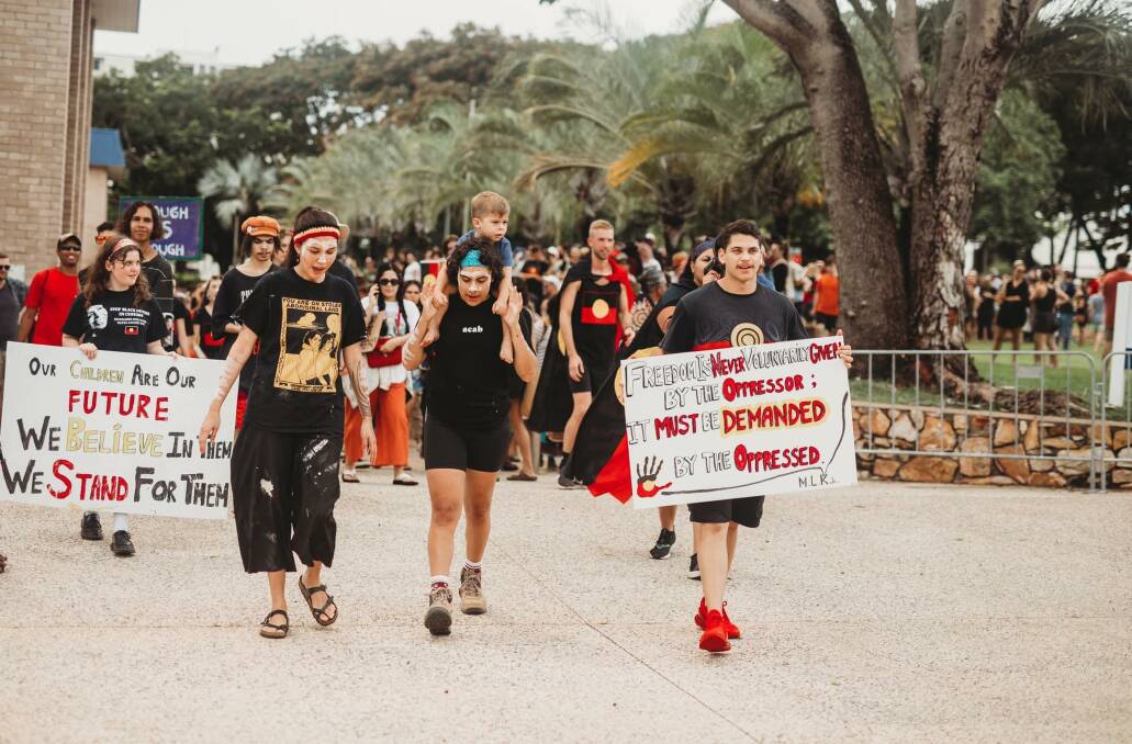 Larrakia women, Sharna Alley and Mililma May with her nephew Reuben Johnson and Sabastian McKenzie lead the Invasion Day protest through Darwin. Picture: Gems Photographic.