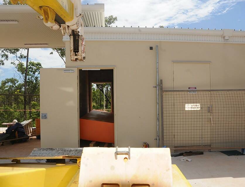 Three workers used a crane to get a 1.8 tonne switchboard through the door of a newly constructed switchboard room at the Palmerston Police Station. Picture: NT Worksafe. 