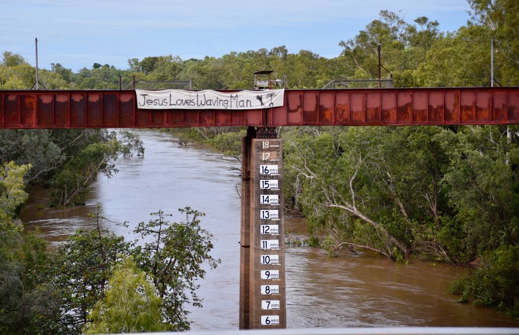 A banner in support of Katherine's waving man Jim Ashworth has been tied to the Katherine Railway Bridge in a bid to save him from bureaucratic red tape. Picture: Roxanne Fitzgerald. 