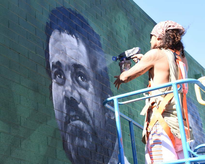 Darwin-based artists Jesse Bell painted Katherine icons Robert Lee and and Raymond Fordimail on Railway Terrace in April, 2020. Picture: Tom Danks. 