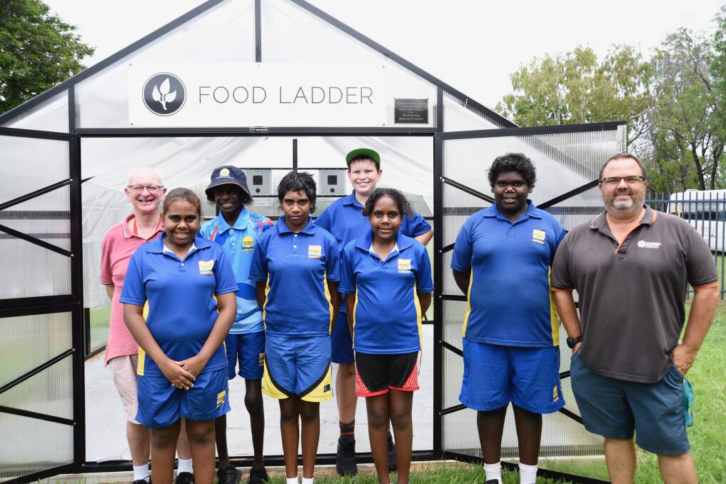 Kintore Street students, Donna Coolwell, Mabel Tapau, Shanaya Coolwell and Selwyn Murphy (front) and Milton Bostock and Harrison Bursle (back) with their teachers Ian Gudgeon and Shayne Cox, have been maintaining the greenhouse as part of a whole school effort. Picture: Roxanne Fitzgerald. 