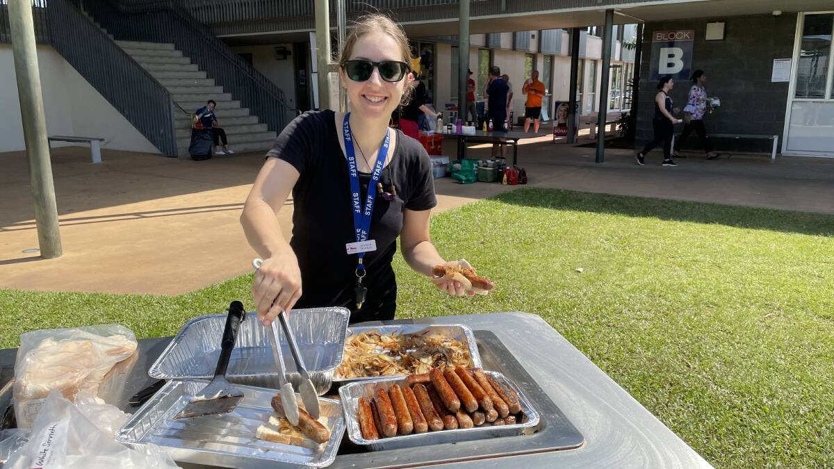 MacKillop College staff member Jessica Donker on BBQ duty, helping to raise money for the school's production of The Lion King. Picture: Sarah Matthews
