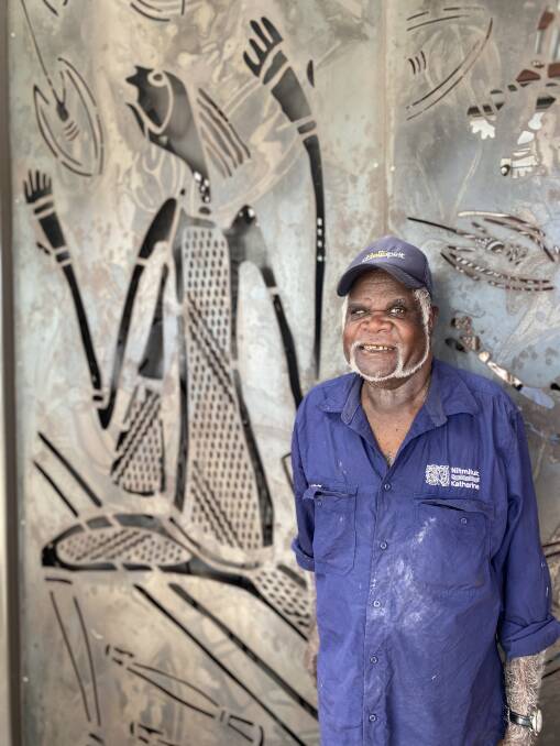 Artist John Dewer in front of the Mimi spirits he designed for the new centre's doors. Picture: Supplied