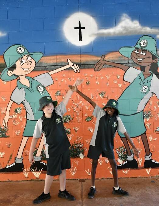 SEEING DOUBLE: Students Silas Wadey and Calamity Wilfred with their unintentional lookalikes in the mural. Picture: Ginny Edwards.
